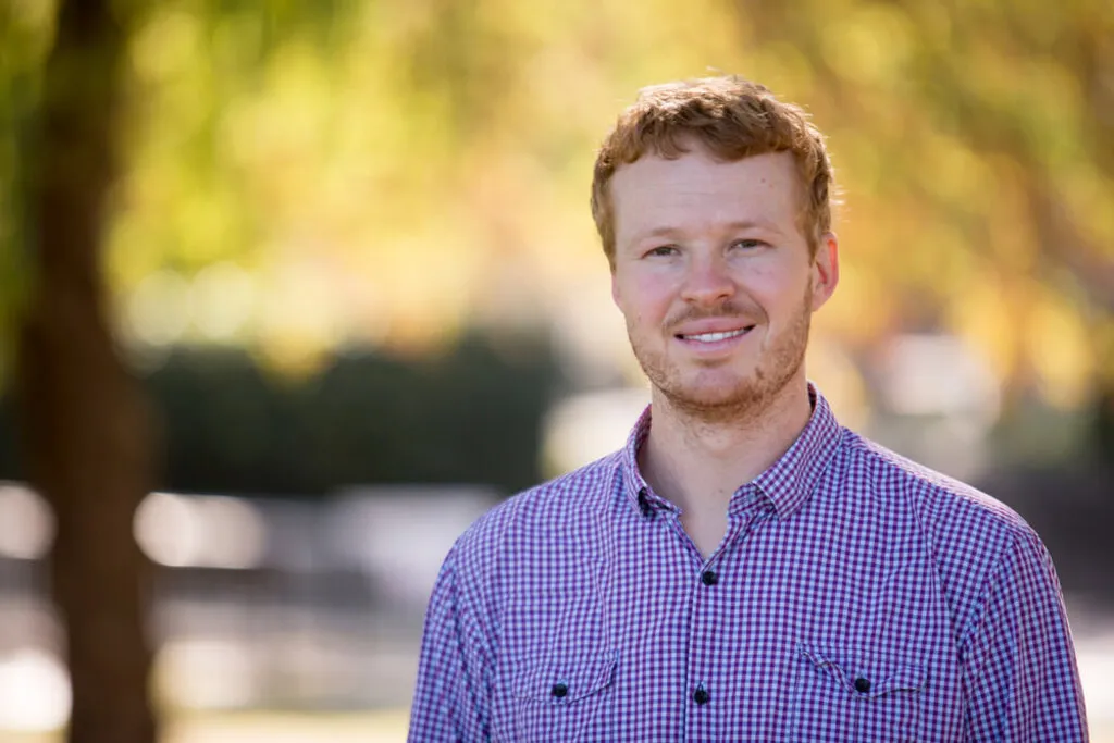 Ben outside on the ANU campus in autumn