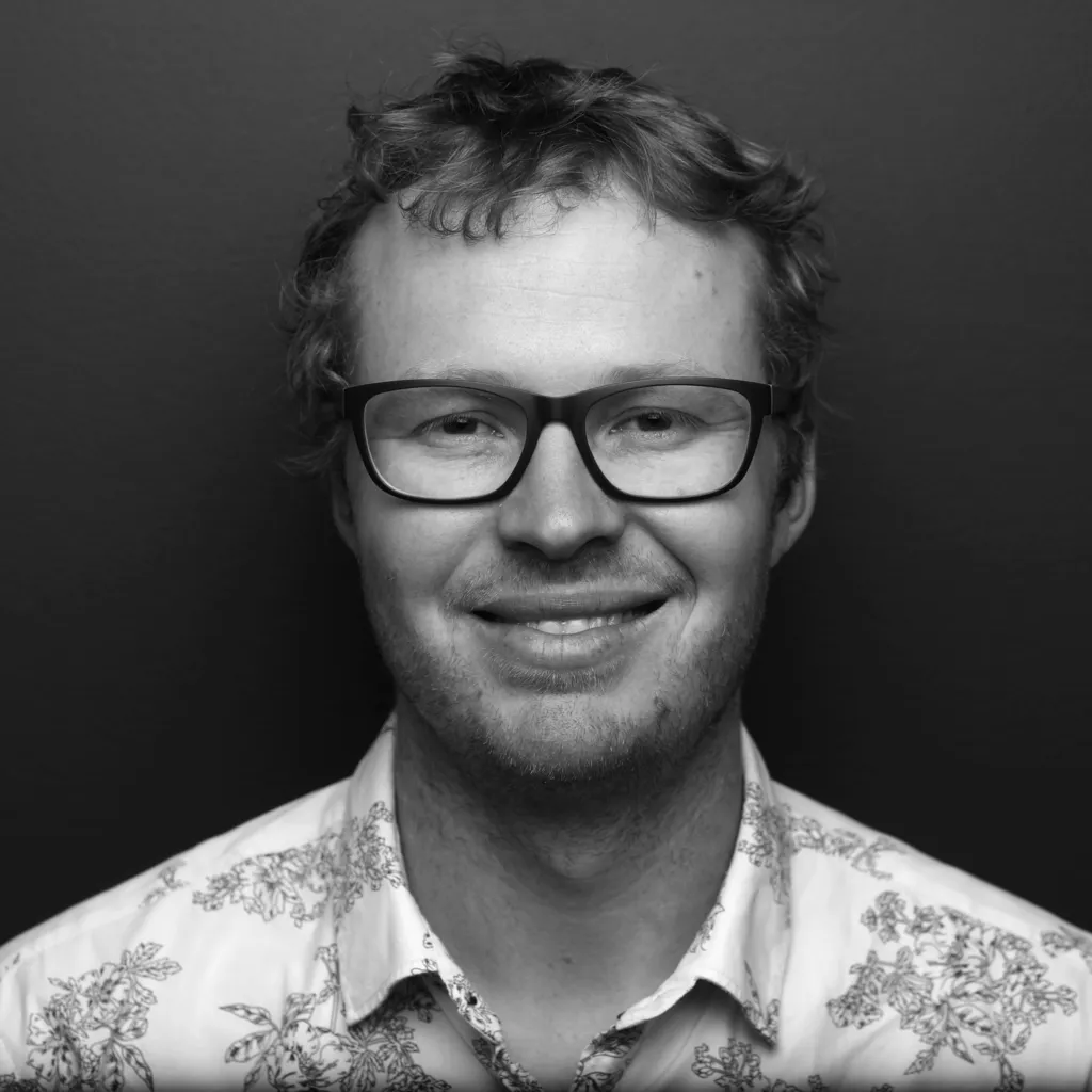 Ben black-and-white headshot inside the ANU Birch building