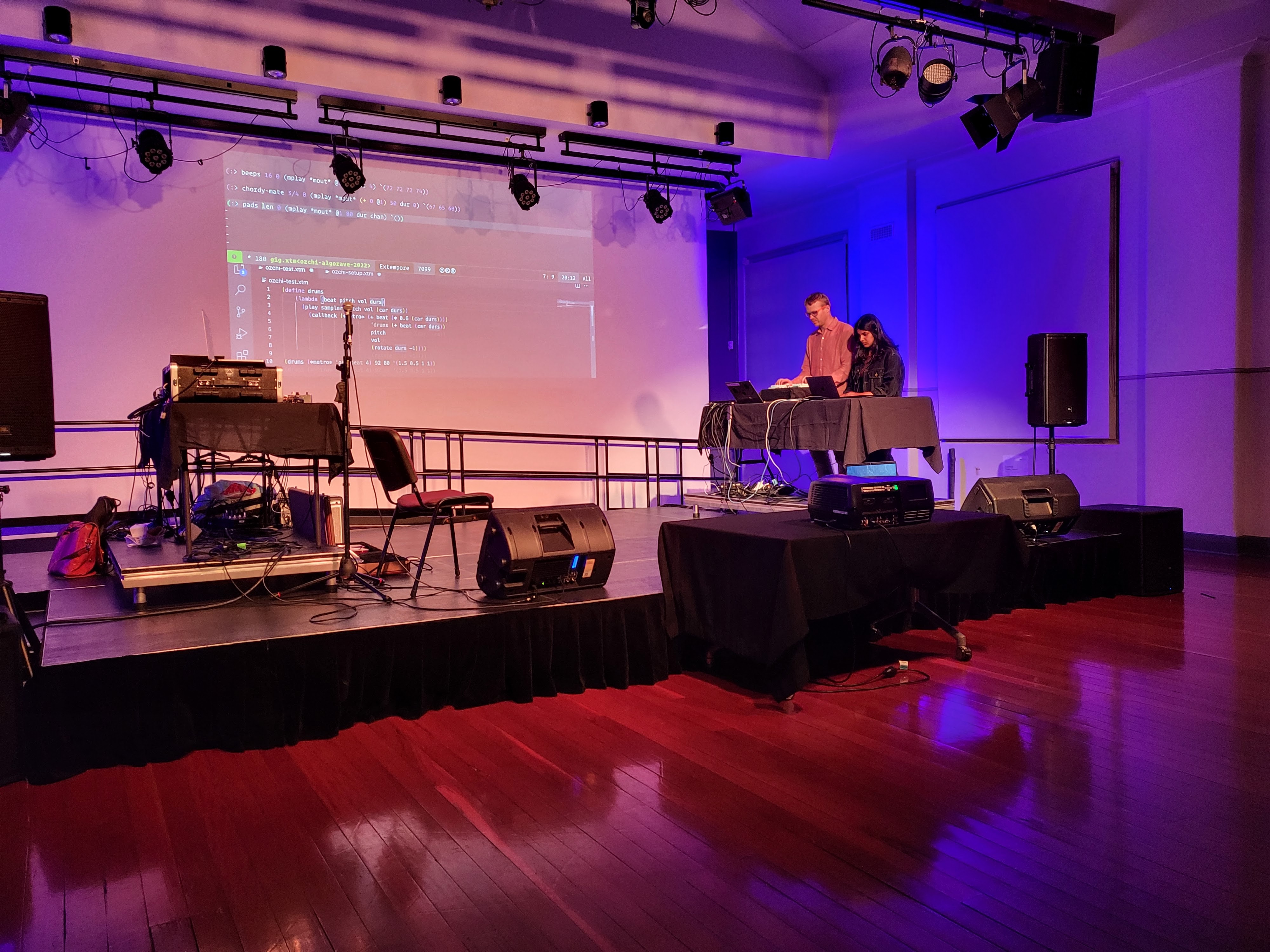 Ben & Ushini on a stage llivecoding at the OzCHI Connected Creativity gig